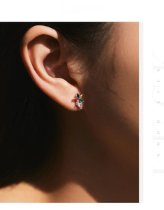 Close-up of a s925 silver stud earring featuring colorful rainbow crystals on an ear