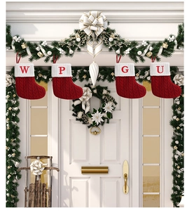Detailed knit Christmas stockings with embroidered letters W, P, G, U on festive wreaths