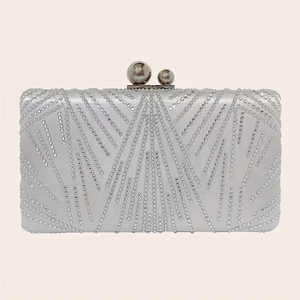 Detail of silver evening clutch featuring intricate beadwork and pearl snap clasps