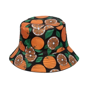 Detail shot of canvas bucket hat featuring vibrant orange fruit prints on a black base