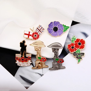 Detailed view of enamel remembrance pins with red poppies and soldier silhouettes