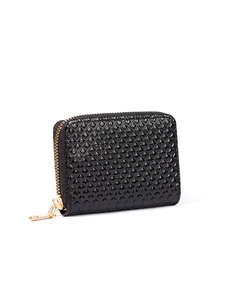 Detail of black glossy patent leather coin purse with quilted pattern and gold zipper