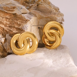 Polished 18k gold double interlocking hoop earrings on natural stone background