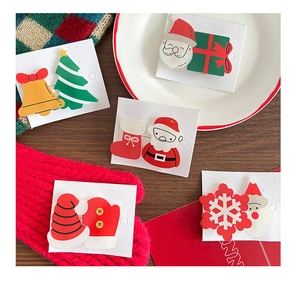 Close-up of assorted Christmas hair clips with Santa Claus and festive tree patterns