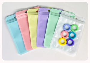 Macro view of macaron colored resealable zip lock bags with colorful rings inside