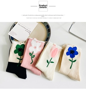 Detailed view of four pairs of floral cotton crew socks in pastel and black tones