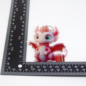 Pink acrylic dragon ornament with size scale showing 6cm height and width on white background