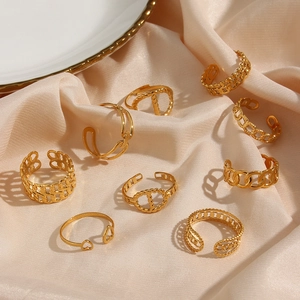 Set of 9 vintage gold-plated stainless steel rings with geometric designs on silk