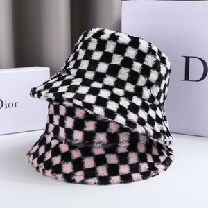 Detail of plush checkerboard bucket hats in black-white and pink-black faux rabbit fur