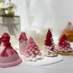 Christmas tree shaped scented candle in pink and white wax with frosted matte texture
