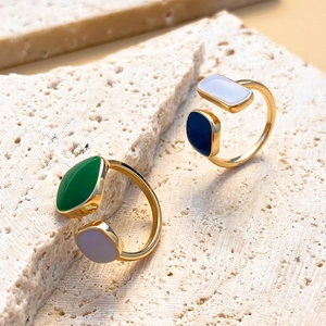 Retro geometric open ring with colorful enamel and zircon on beige stone display