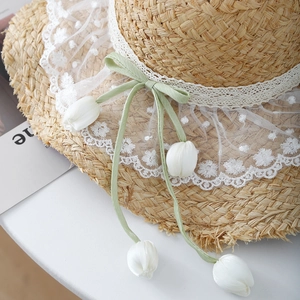 Handmade raffia sun hat with floral lace trim and green ribbon tulip pendants