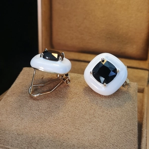 Square ceramic cufflinks in white and gold finish with black gemstone inlay for formal wear