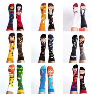 Collection of nine pairs of creative asymmetrical cotton crew socks with fun cartoon motifs