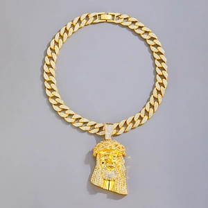 Hip hop gold Cuban link necklace with iced out Jesus head pendant on grey background