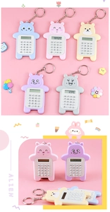 Close-up of five cute cartoon bear 8-digit mini calculators in assorted pastel colors