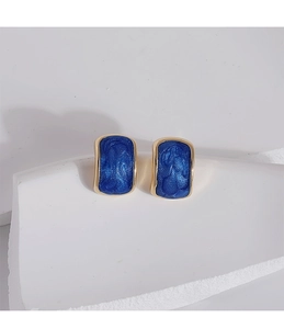 Macro shot of blue starry enamel earrings with gold plating and s925 silver needles