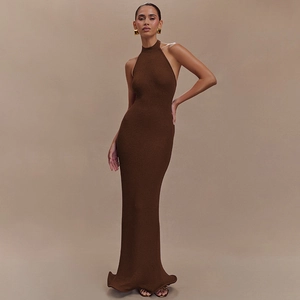 Detail of slim fit dark brown halter neck knitted maxi dress with a floor-length hemline