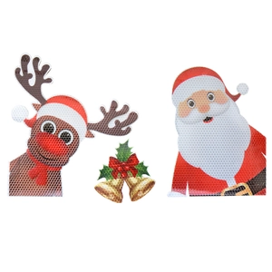Macro shot of Christmas gnome and reindeer magnets with honeycomb reflective texture