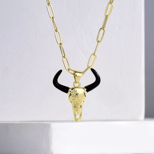 18K gold plated bull skull pendant necklace with black horns on white stone base