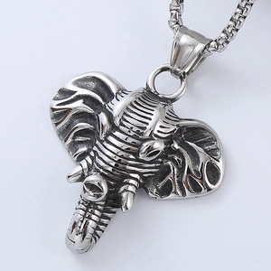 Close-up of vintage silver elephant head pendant with detailed textures and box chain necklace