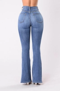 Rear view of high waist flared jeans showing push-up effect and slim fit denim silhouette