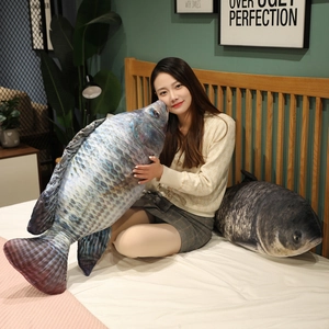 Detailed comparison of realistic fish plush pillow sizes shown in a cozy bedroom setting