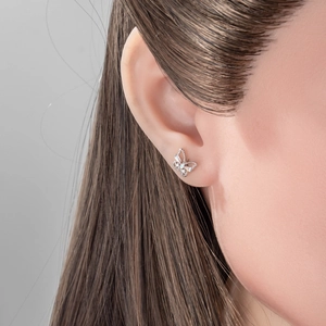 Delicate silver butterfly stud earring with clear zircon crystals on model ear