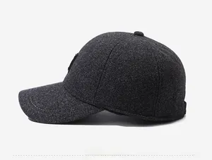 Detail view of dark grey textured wool blend fabric on a men's winter baseball cap