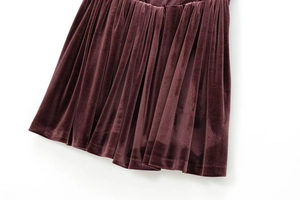 Detailed close-up showing the premium velvet texture and pleated fabric design of the dress