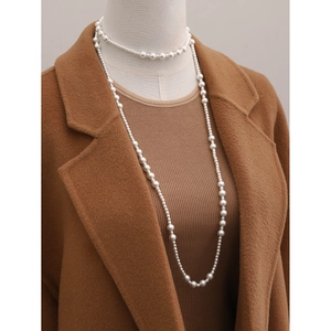 Multilayered 18K gold stainless steel long necklace with asymmetrical white pearls on model