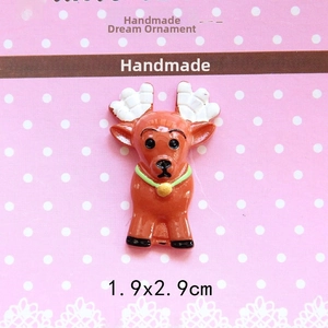 Detailed view of a Christmas reindeer resin charm with green collar for DIY crafts