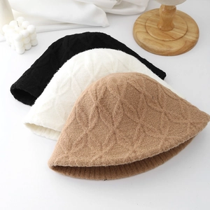 Chic winter plush bucket hats in black, white, and camel with textured knit patterns