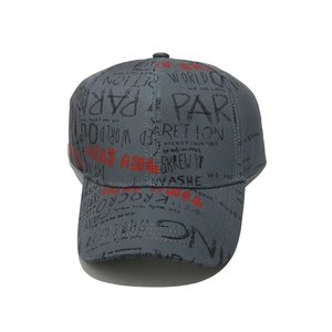 Detail view of charcoal gray baseball cap featuring black and red graffiti style lettering