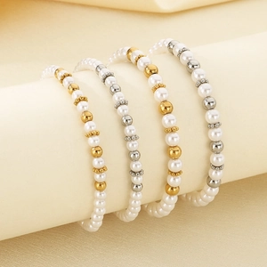 Baroque pearl bracelets with gold and silver beads displayed on a light beige roll