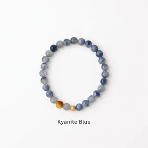 Detail of Misty Blue beaded bracelet with natural stone texture and golden accents