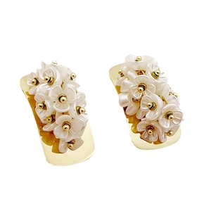 Elegant gold earrings featuring intricate white 3D floral petals and golden bead accents