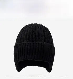 Détail du bonnet d'hiver en maille épaisse avec protège-oreilles et étiquette logo flocon