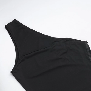 Close-up detail of smooth black knit fabric showing shoulder strap and fine stitching