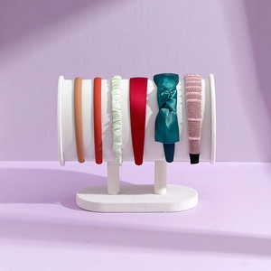 Velvet display stand showing colorful velvet and satin headbands in various styles