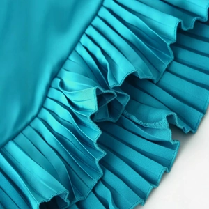 Elegant emerald satin pleated dress with textured diagonal folds for a sophisticated look