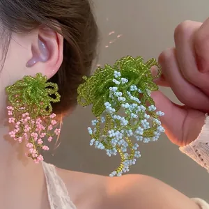 Handmade beaded flower tassel earrings in pink and blue colors for a sweet forest style