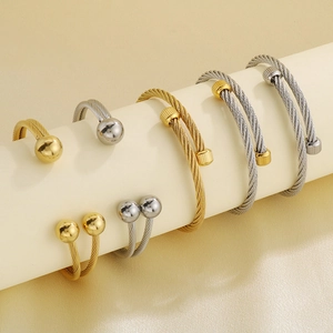 Hip hop cable wire open bangles in gold and silver finish on white display stands