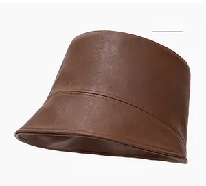 Detail view of coffee brown PU leather bucket hat with fine texture and stitched seam