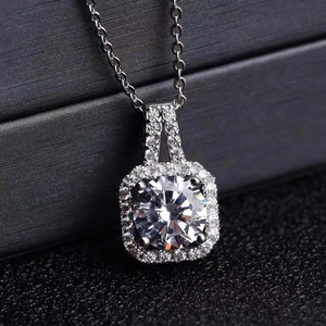 Macro shot of silver square halo pendant necklace with brilliant cut moissanite stone
