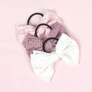 Three-piece set of girls bow hair ties in pink and white with hollow eyelet patterns