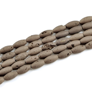 Macro detail of olive-shaped natural druzy agate beads with rustic earthy textures