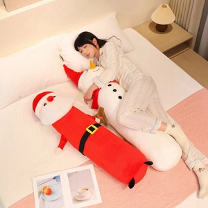 Long Santa and snowman plush bolster pillows shown in a cozy bedroom sleep setting