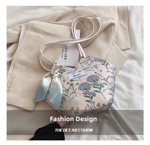 Detailed close-up of a floral canvas tote bag with elegant blue flower jacquard patterns