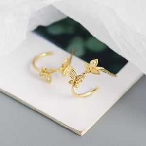 Makroaufnahme goldener Schmetterlings-Creolen mit funkelnden Kristallen und S925 Silber
